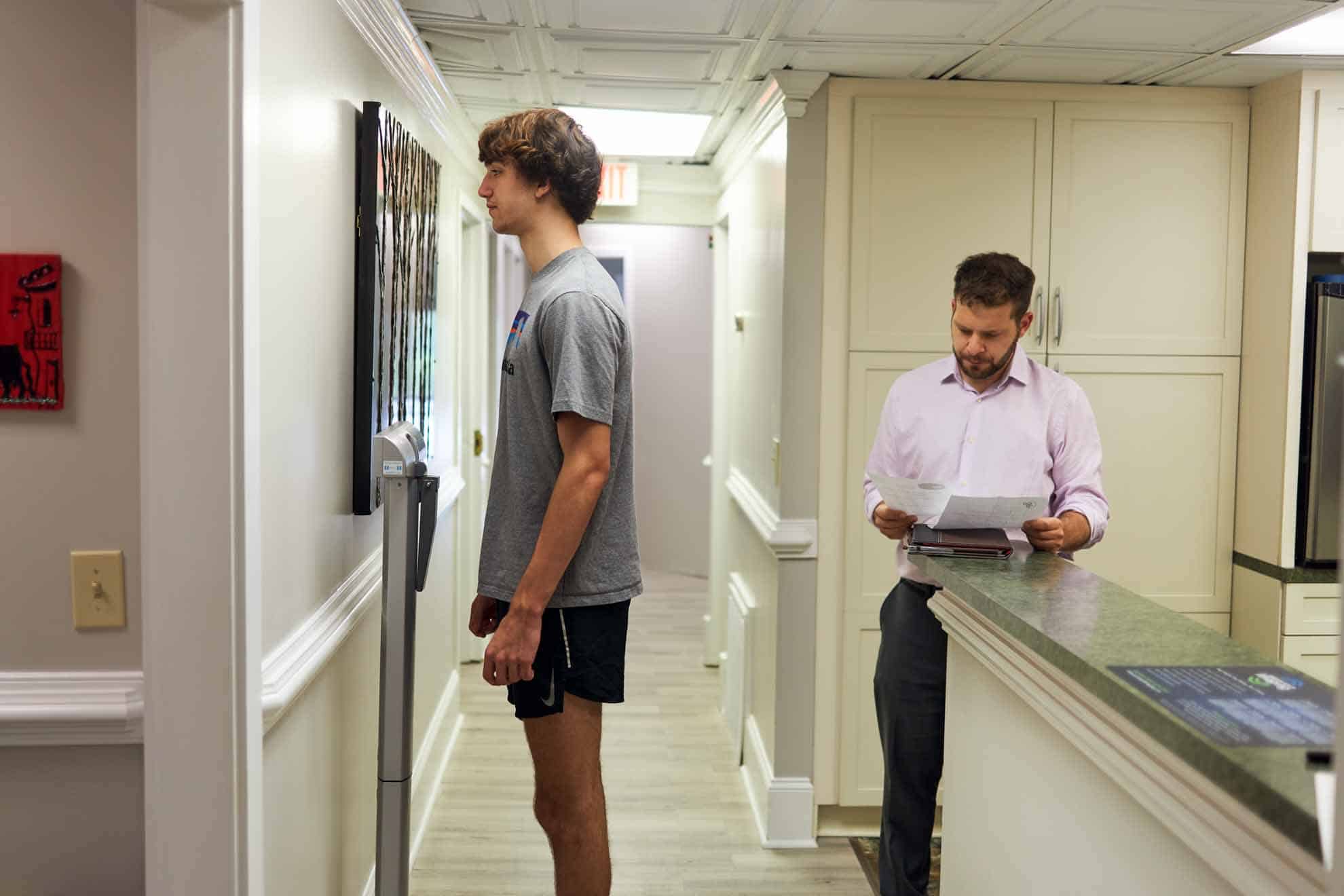man on standing on scale at Highland Urgent Care & Family Medicine