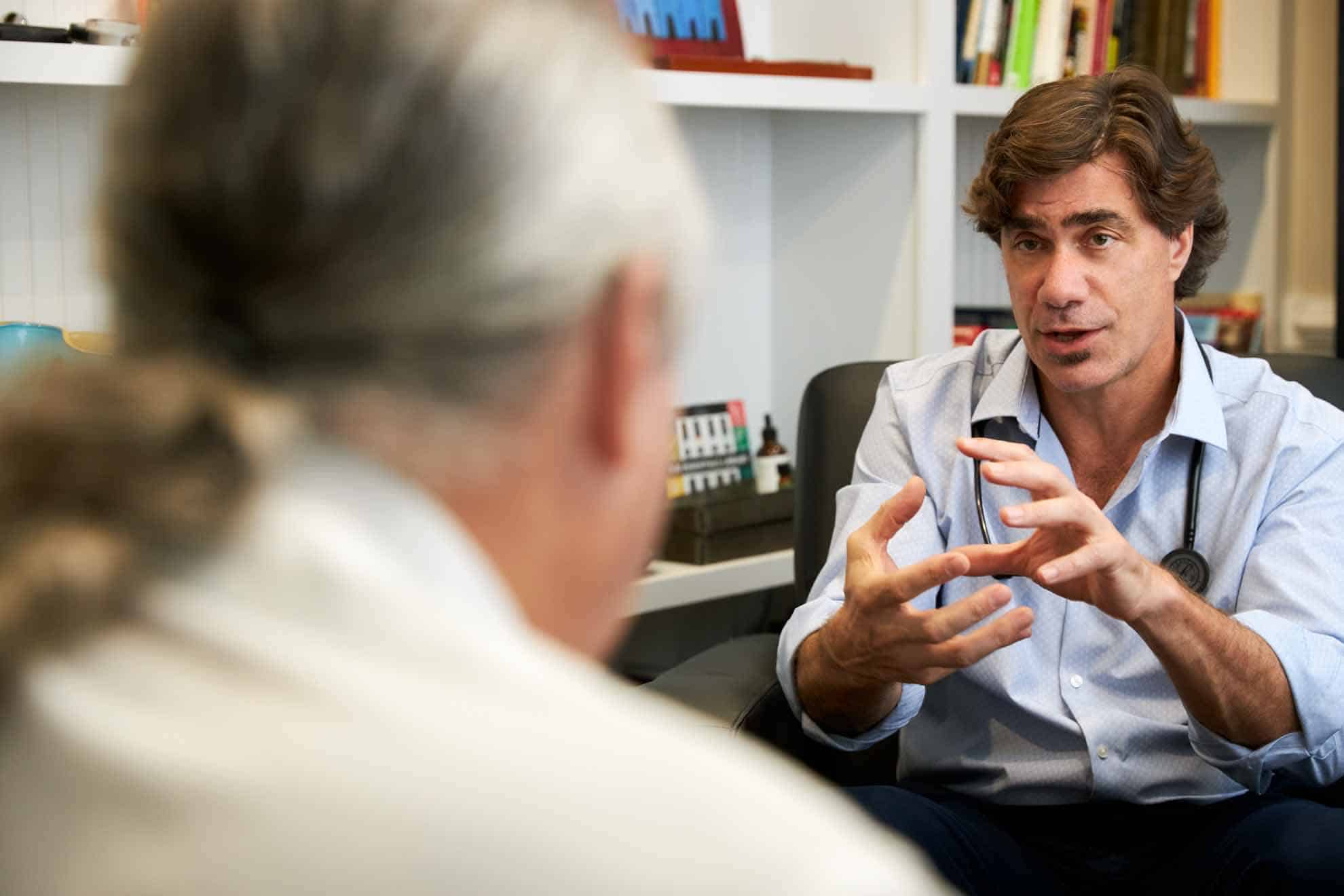 Dr Nicholas Beaulieu talking with patient in his office